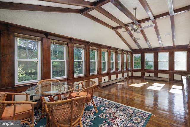 sunroom with ceiling fan, vaulted ceiling with beams, and a baseboard radiator