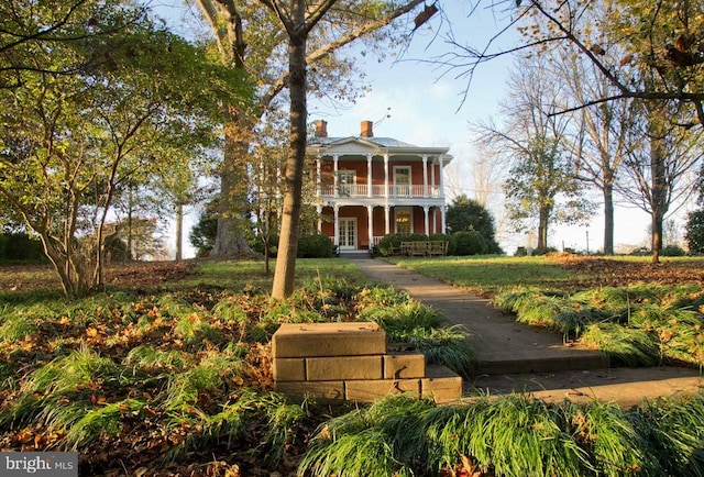 view of front of house with a balcony and covered porch