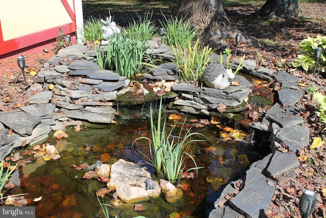 exterior details featuring a garden pond