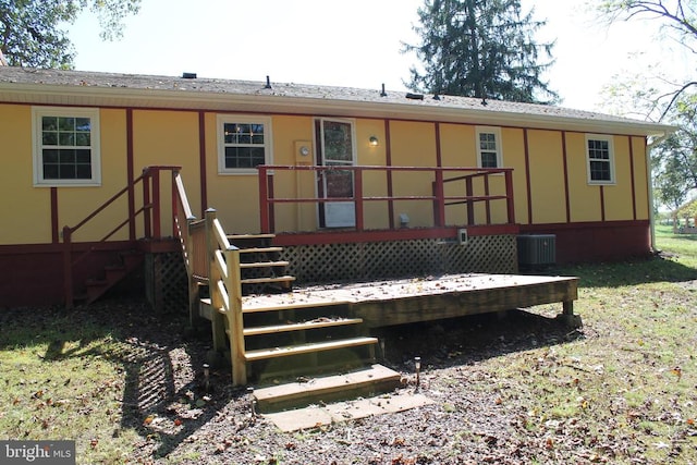 rear view of house with cooling unit and a deck