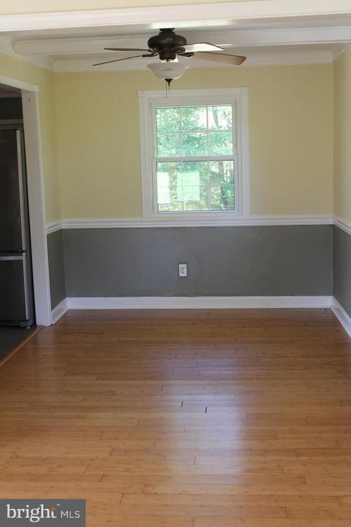 spare room featuring hardwood / wood-style floors and crown molding