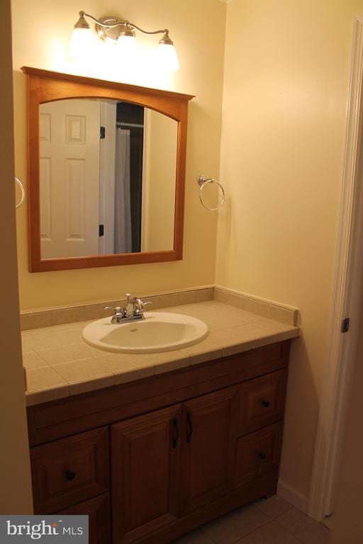 bathroom with tile patterned flooring and vanity