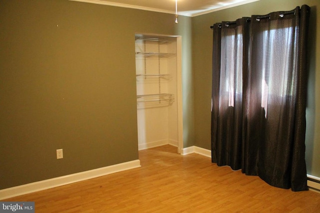 spare room with hardwood / wood-style flooring and ornamental molding