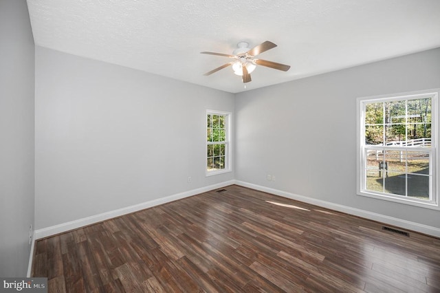 spare room featuring a textured ceiling, ceiling fan, and dark hardwood / wood-style flooring