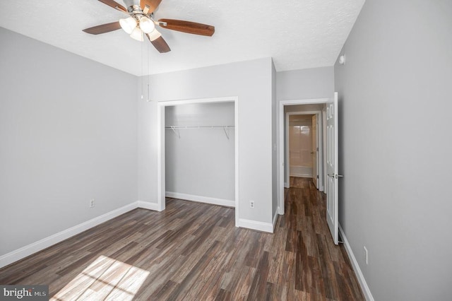 unfurnished bedroom featuring a textured ceiling, ceiling fan, a closet, and dark hardwood / wood-style flooring