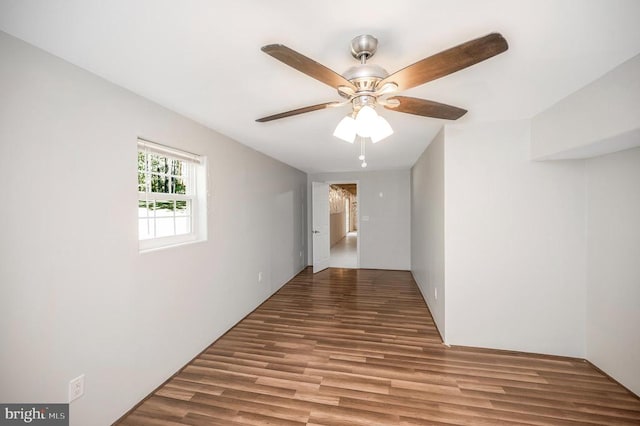 unfurnished room with ceiling fan and hardwood / wood-style flooring