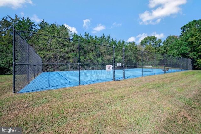 view of sport court featuring a yard