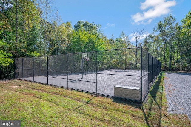 view of tennis court with a lawn