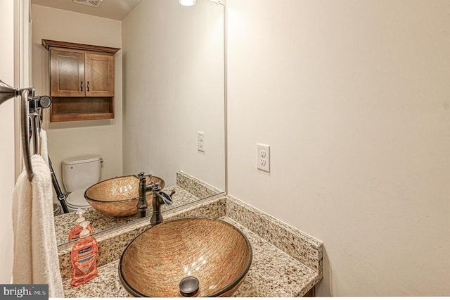 bathroom featuring vanity and toilet