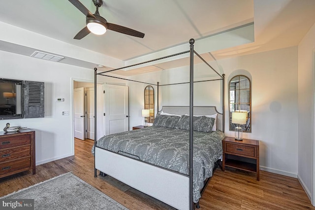 bedroom featuring ceiling fan and dark hardwood / wood-style floors