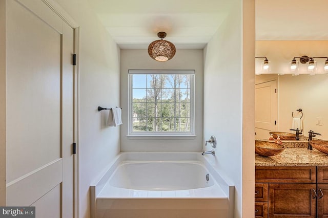 bathroom with a bathing tub and vanity