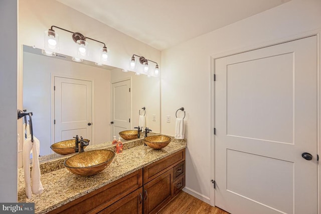 bathroom with vanity and hardwood / wood-style floors