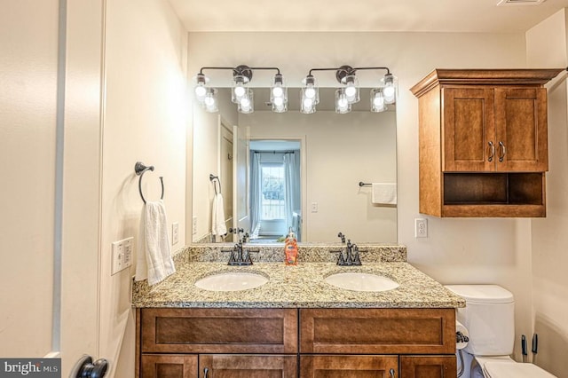 bathroom featuring vanity and toilet