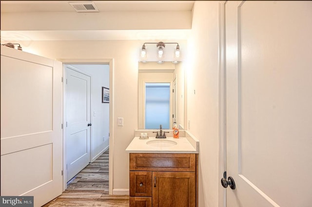 bathroom with hardwood / wood-style floors and vanity