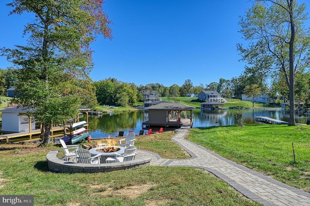 view of yard with an outdoor fire pit and a water view