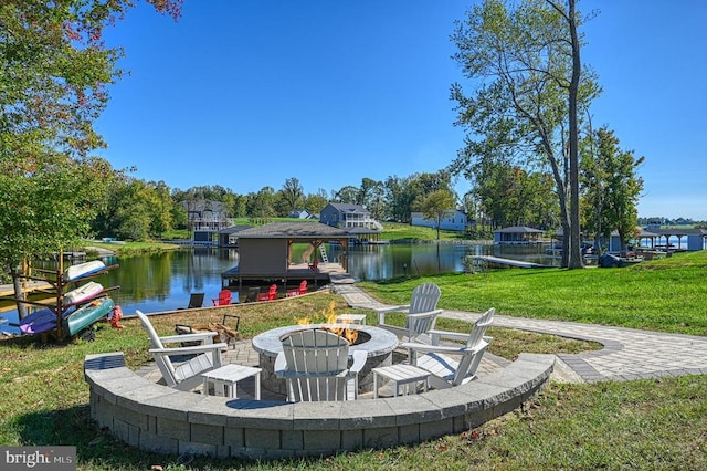 view of patio / terrace featuring a water view and a fire pit