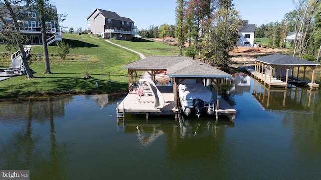 dock area with a water view and a lawn