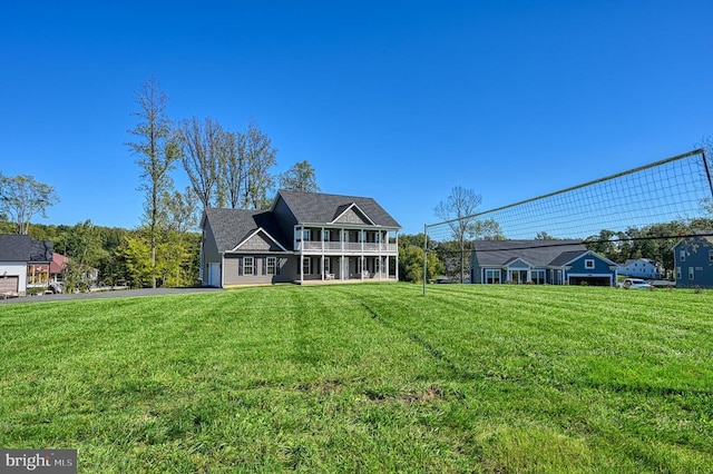 rear view of property featuring a lawn