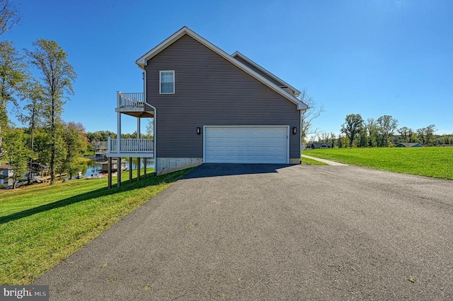 view of property exterior with a balcony, a garage, a yard, and a water view