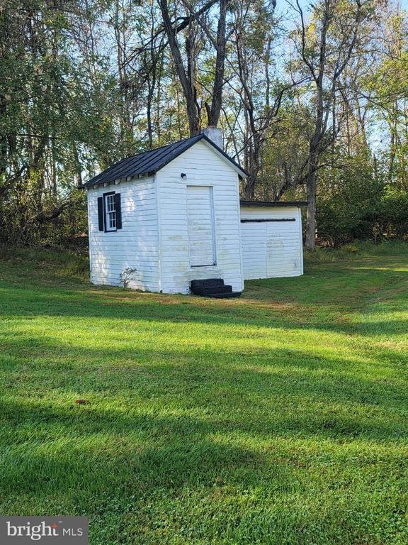 view of outdoor structure with a lawn