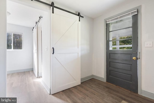 entryway with wood-type flooring and a barn door