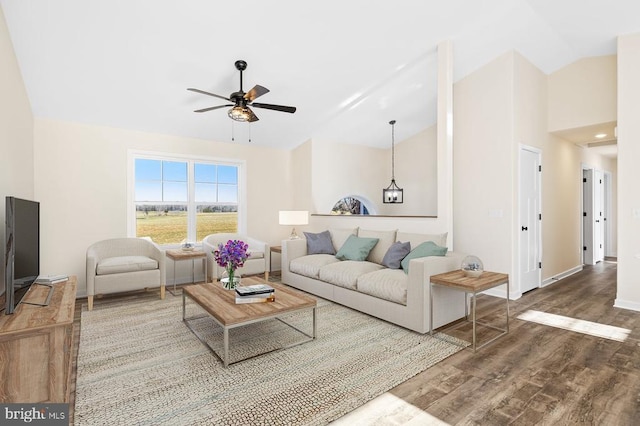 living room featuring hardwood / wood-style floors, ceiling fan, and lofted ceiling