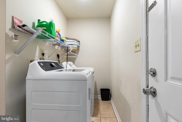 washroom with washer and clothes dryer and light tile patterned flooring