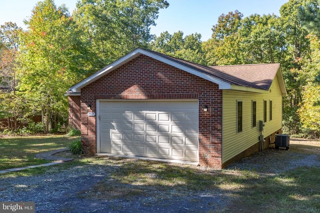 view of home's exterior featuring central AC, a yard, and a garage