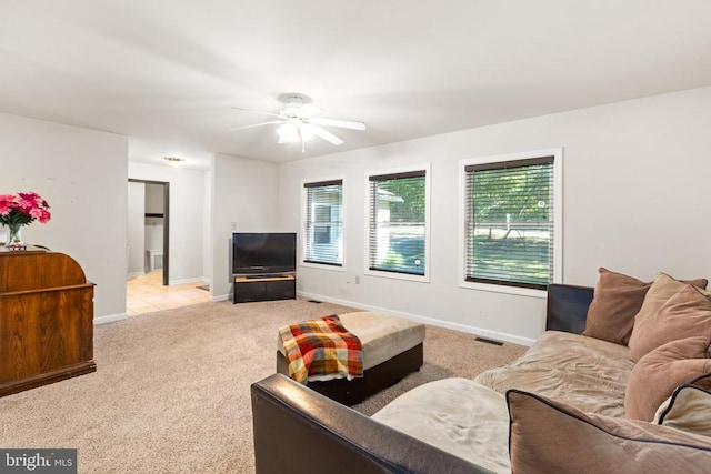 living room featuring light colored carpet and ceiling fan