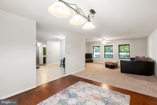 living room with ceiling fan and hardwood / wood-style flooring