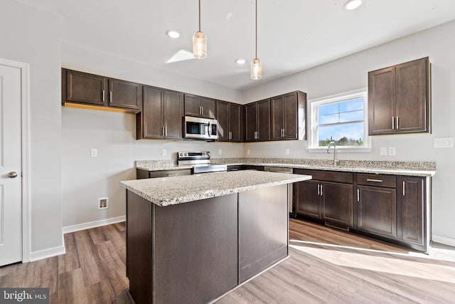 371 Glenmore Ln, Keswick, VA 22947 - kitchen featuring appliances with stainless steel finishes, light wood-style floors, dark brown cabinetry, recessed lighting, and decorative light fixtures