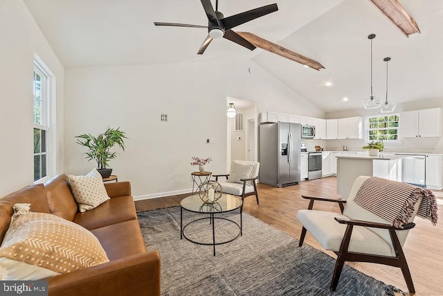 living room featuring beamed ceiling, high vaulted ceiling, light hardwood / wood-style floors, and ceiling fan