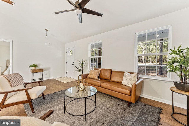 living room with lofted ceiling, hardwood / wood-style floors, and ceiling fan