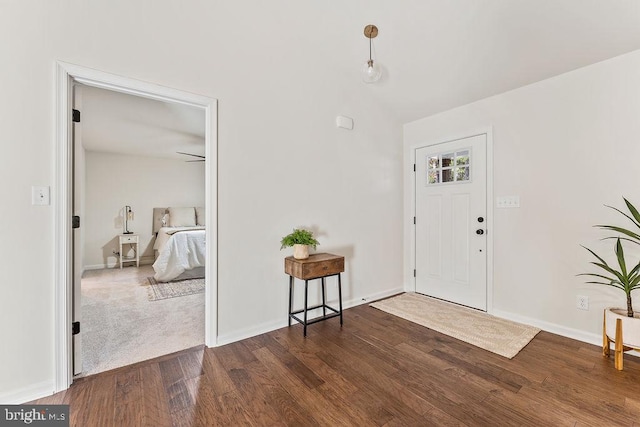 entrance foyer featuring dark wood-type flooring and vaulted ceiling