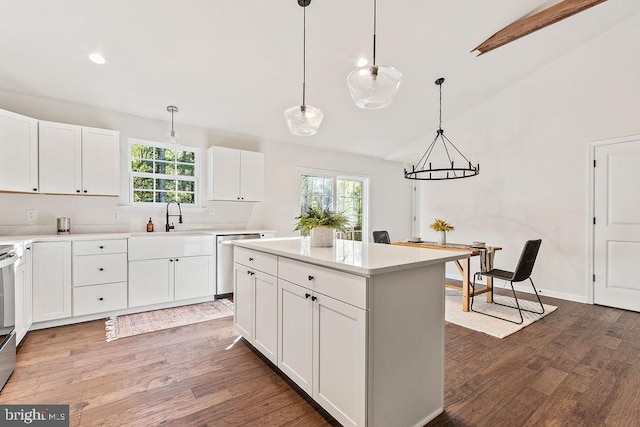 kitchen with hardwood / wood-style flooring, hanging light fixtures, and white cabinets