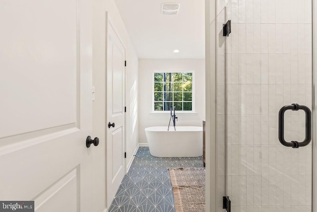 bathroom featuring shower with separate bathtub and tile patterned flooring