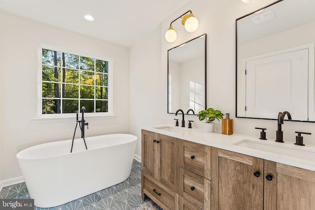 bathroom featuring vanity, a tub, and tile patterned flooring