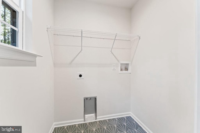 laundry area featuring hookup for an electric dryer, hookup for a washing machine, and tile patterned floors