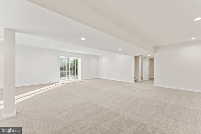 basement featuring light carpet