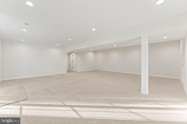 basement featuring light colored carpet