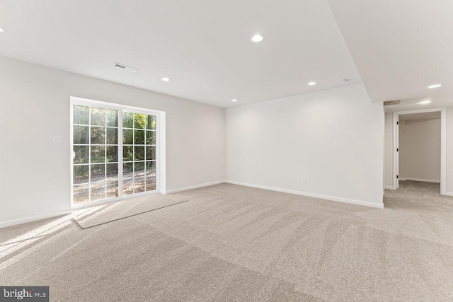 unfurnished room featuring light carpet