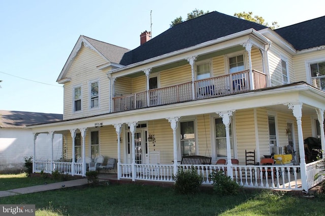 farmhouse inspired home with a porch and a front yard