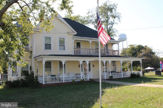 view of front of home featuring a porch, a front lawn, and a balcony