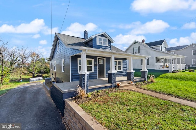 bungalow with a front yard, central AC, and a porch