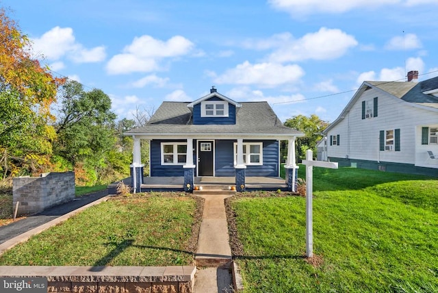 bungalow featuring a front yard and covered porch