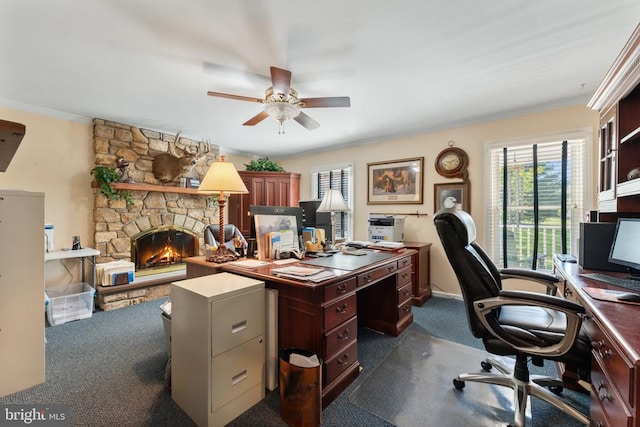 office area with dark carpet, ornamental molding, a fireplace, and ceiling fan