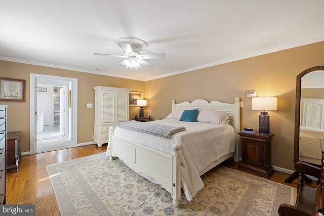 bedroom featuring ornamental molding, light wood-type flooring, and ceiling fan