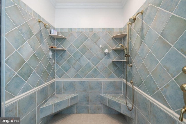 bathroom with tiled shower and ornamental molding