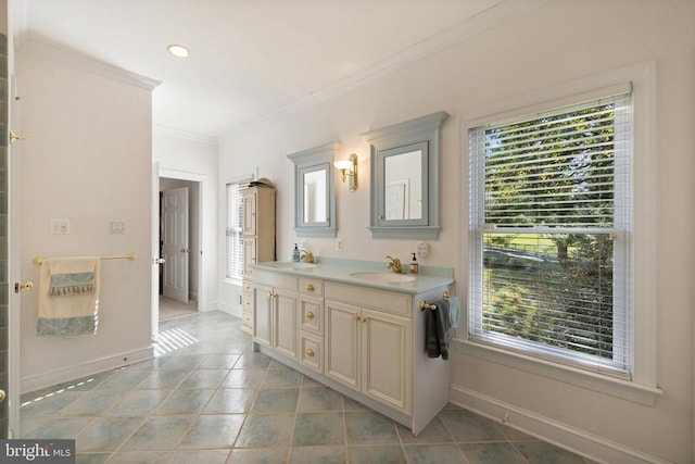 bathroom with vanity, crown molding, tile patterned floors, and a wealth of natural light