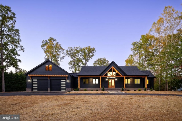 view of front of house with a porch and a garage